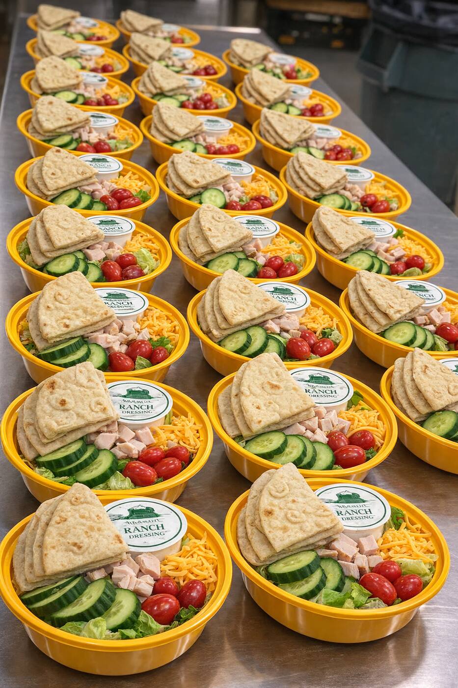Pita-and-ranch chef salad bowls with diced turkey, cucumber, cherry tomatoes, and shredded cheese — Halal protein on request