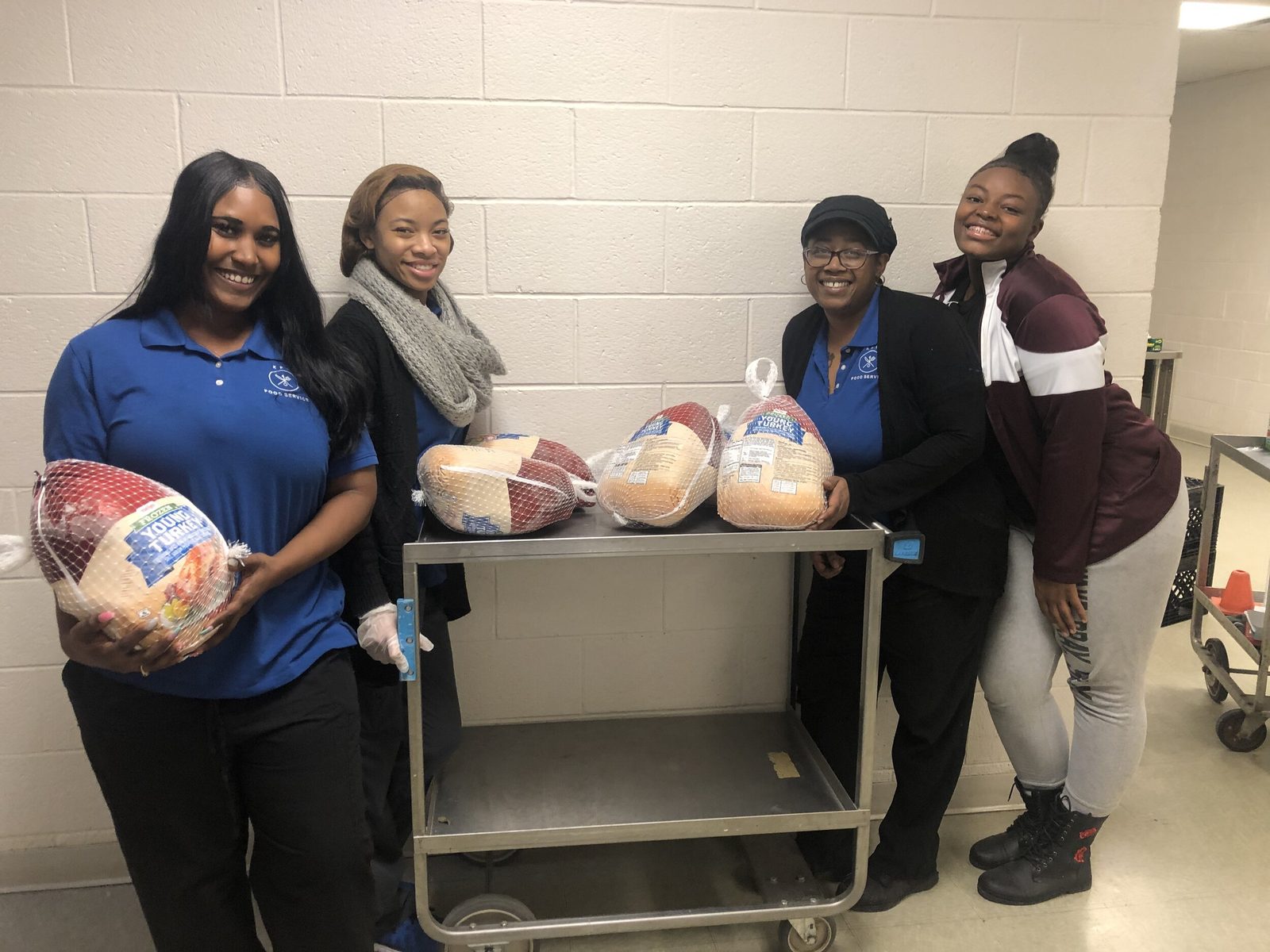 KEYS staff and volunteers staging hundreds of turkeys on rolling carts inside the commissary kitchen ahead of the annual Thanksgiving distribution